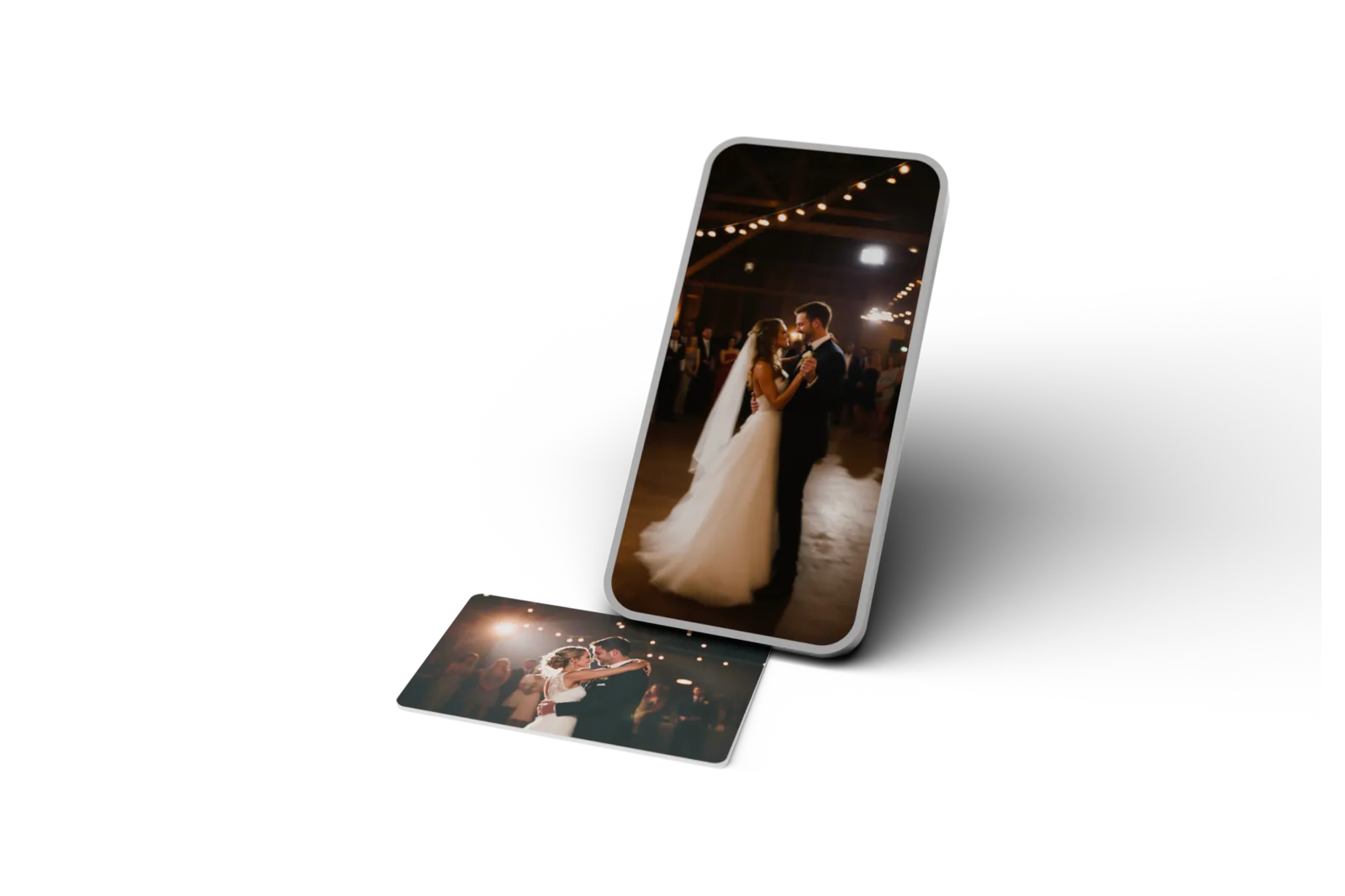 A Dote card printed with a wedding photograph, standing beside a phone playing the video the card opens